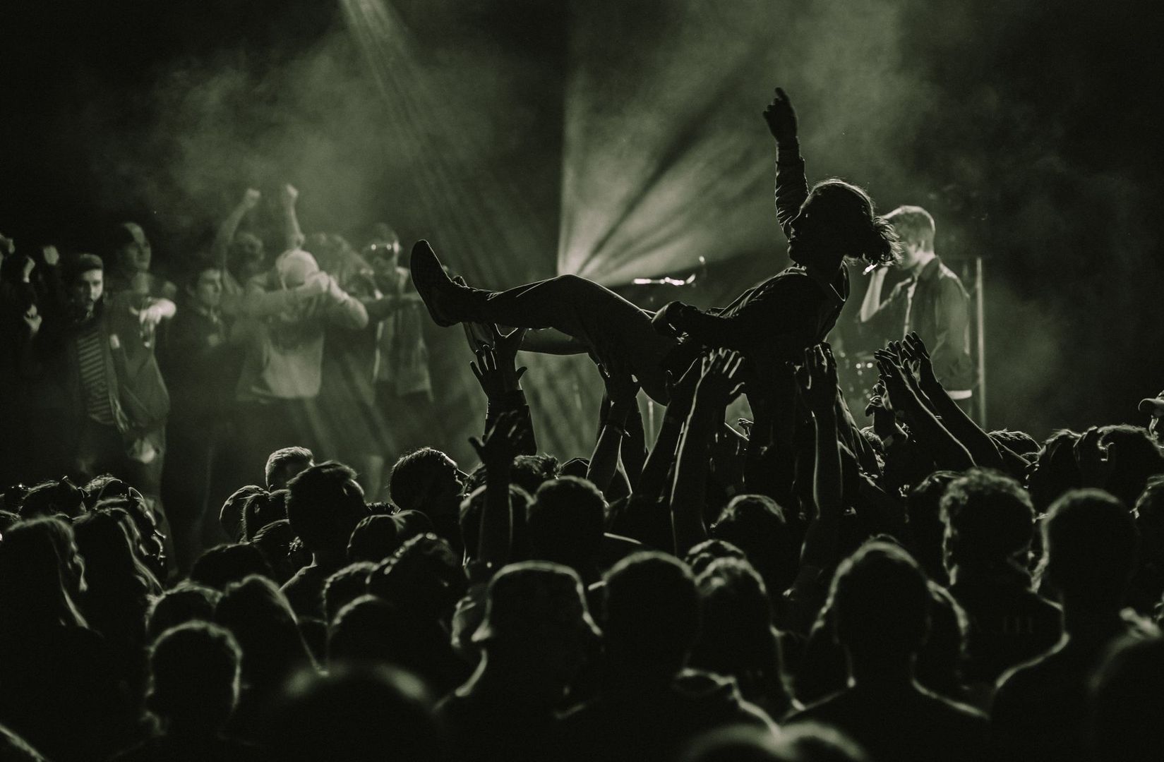 Crowdsurfer wird von vielen Händen durch ein dichtes Konzertpublikum getragen